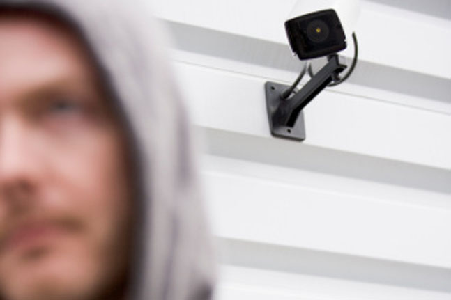 Surveillance Camera And Young Man In Hooded Sweatshirt